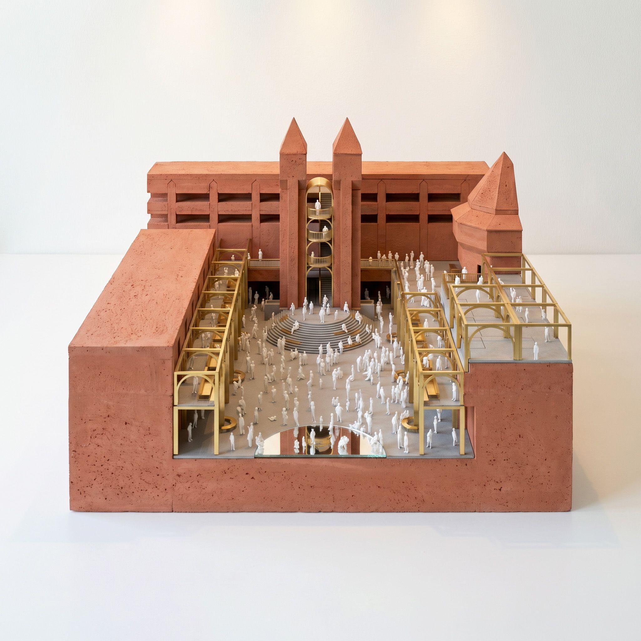 Physical study model for Ealing Broadway, pale timber colonnades set against clay massing with small figures populating the square on a weekend day