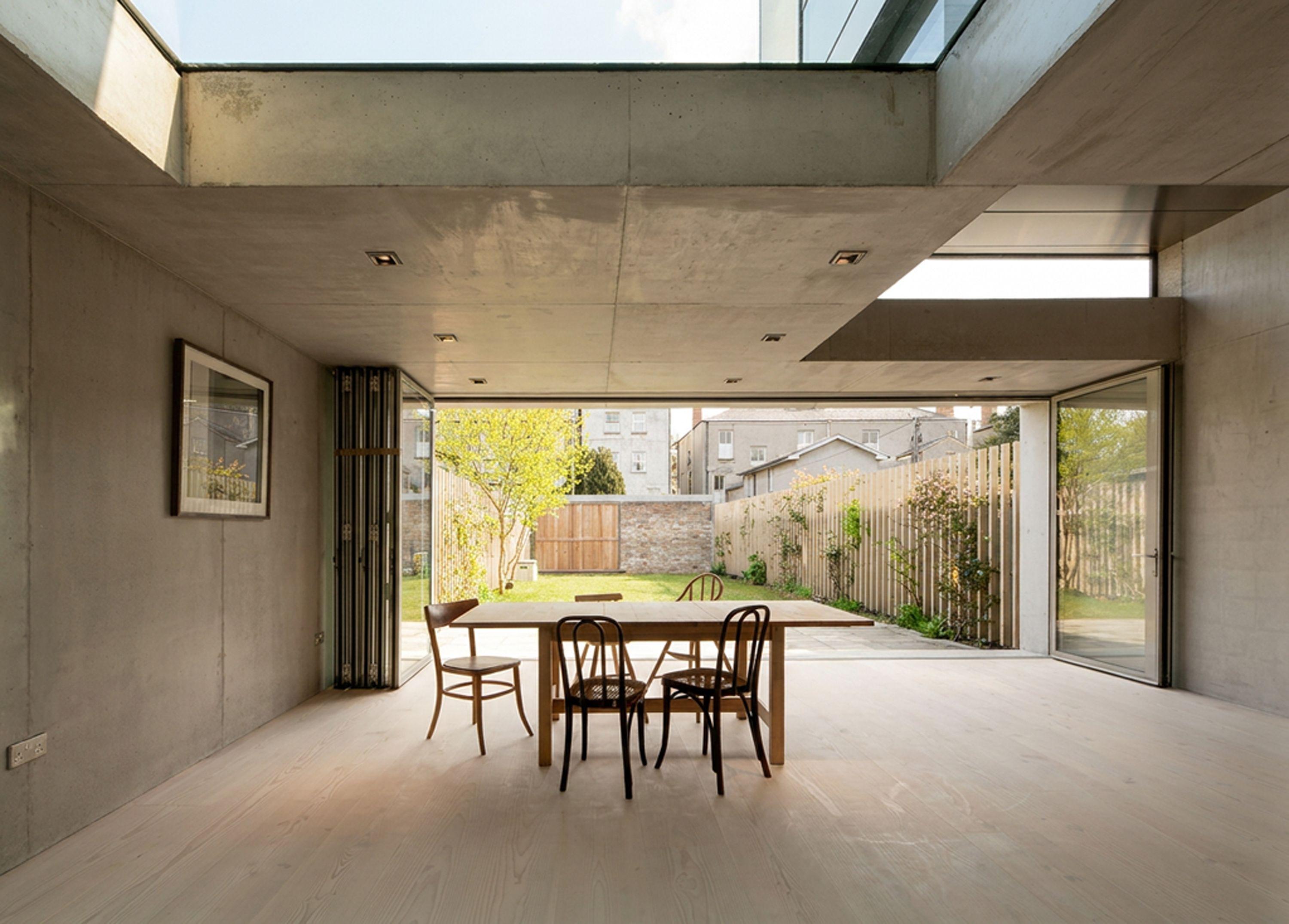 Dining extension at Half Landings House with folded doors fully open to the garden, a rooflight above and Douglas fir floor throughout.