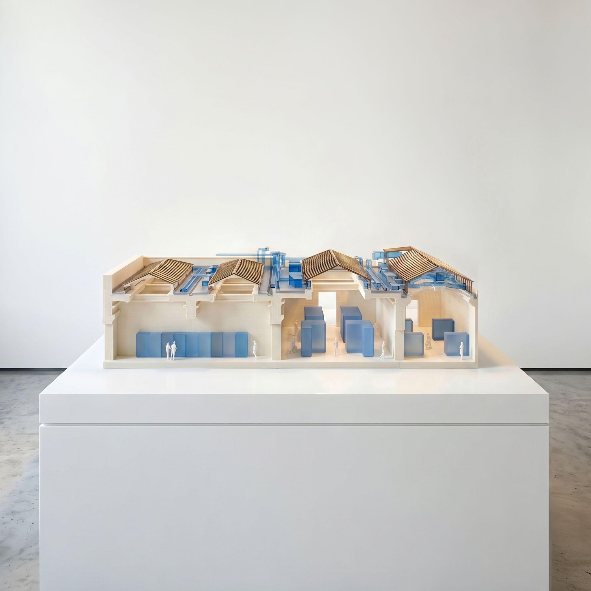 Sectional model of the British Museum's North Egypt Galleries, showing the pitched roofs and rooflights above the gallery spaces, with services and collection objects marked in blue.