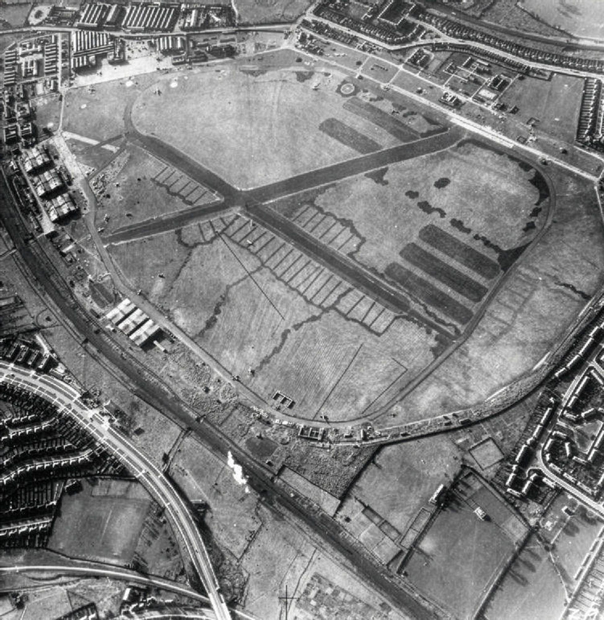 Archival aerial photograph of Hendon Aerodrome, London, the open airfield ringed by its taxiway